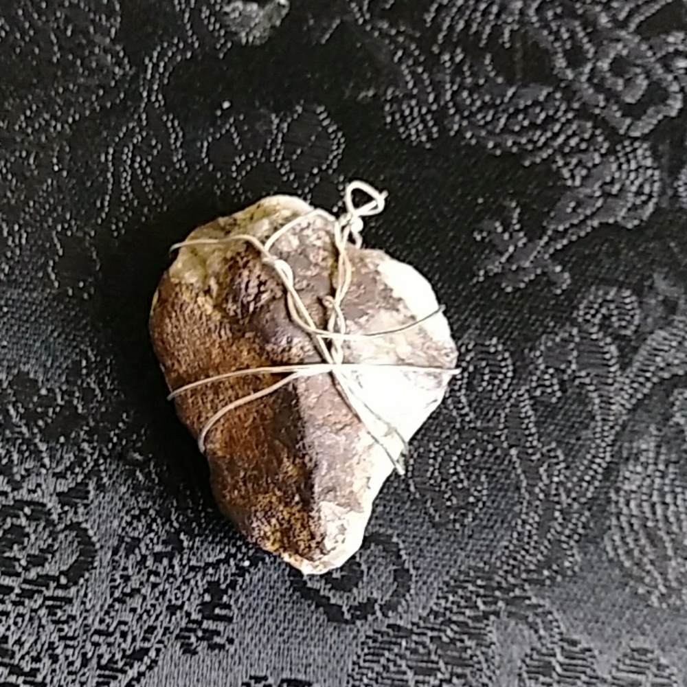 Large heart shaped multicolored wire wrapped stone